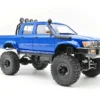toyota hilux 96 wpl c64 auto rc escala 1-16 sobre superficie rocosa o fondo blanco