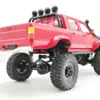 toyota hilux 96 wpl c64 auto rc escala 1-16 sobre superficie rocosa o fondo blanco
