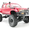 toyota hilux 96 wpl c64 auto rc escala 1-16 sobre superficie rocosa o fondo blanco